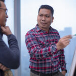 Indonesian employee in Jakarta office talking and discuss for their job